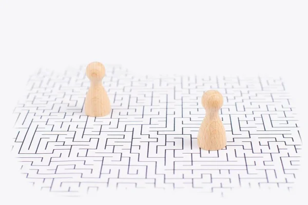 Men stand in the middle of a labyrinth, searching for a solution to exit, finding a strategy, challenge and problem solving concept