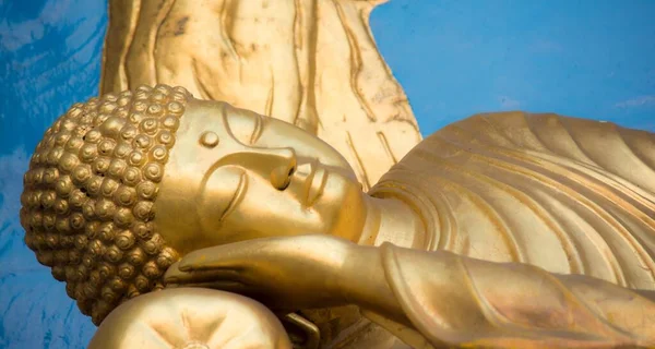 Closeup Lying Golden Statue Buddha Blue Background — Stock Photo, Image