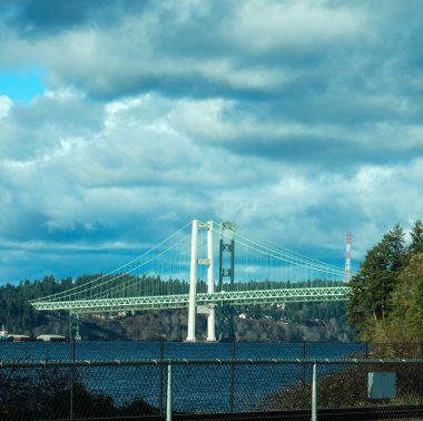 Güneşli bir günde uzun ve uzun bir köprü ve bulutlu bir gökyüzü.