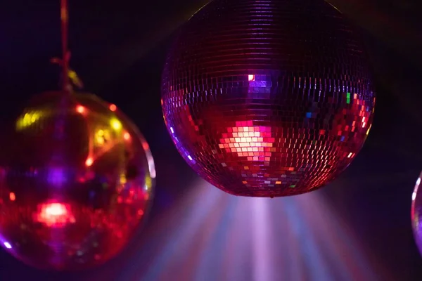 Closeup Shot Disco Balls Hanging Ceiling Bright Pink Red Lights — Stock Photo, Image