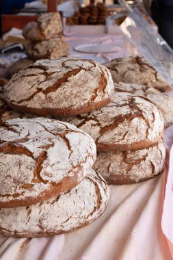 Marketteki bir avuç çıplak kırsal ekmeğin dikey çekimi.