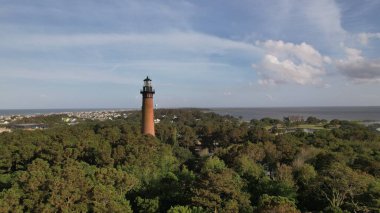 Currituck Sahili Deniz feneri Corolla, Kuzey Carolina 'da yemyeşil ağaçlarla çevrili.