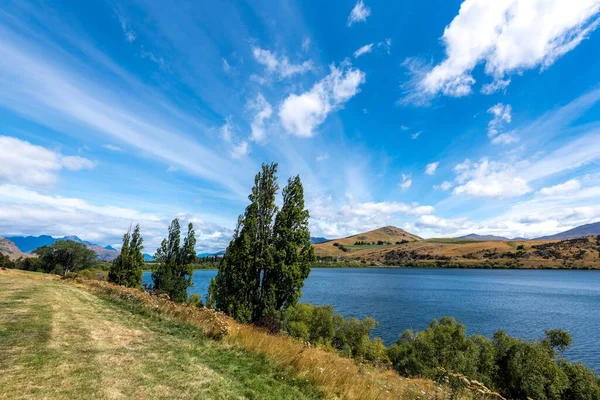 Uma Vista Panorâmica Corpo Água Cercado Por Árvores Colinas Sob — Fotografia de Stock