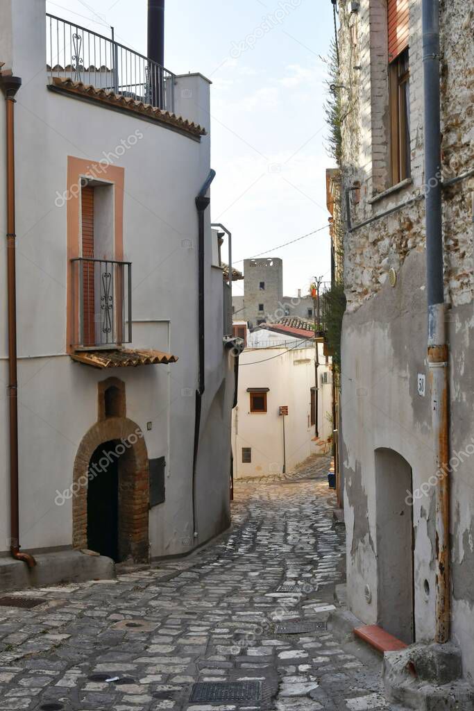 A narrow street between the old houses of an ancient town in Matera province, Italy.