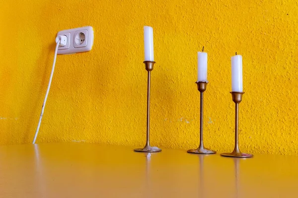 White Candles Candle Holders Yellow Wall Power Socket — Stock Photo, Image