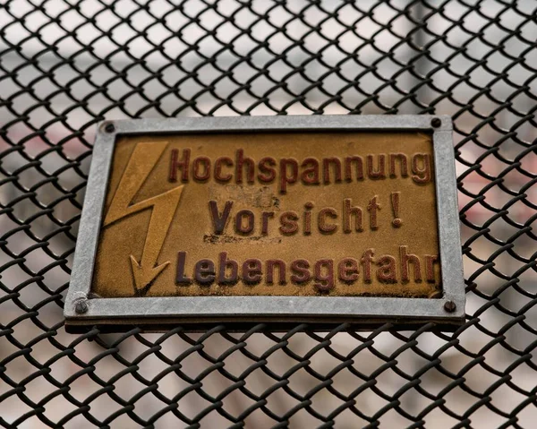 Closeup Metallic Signage Warning High Voltage Caution Risk Death German — Stock Photo, Image