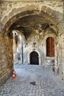 A narrow street between the old stone houses of Campo di Giove, a medieval village in the Abruzzo region of Italy.