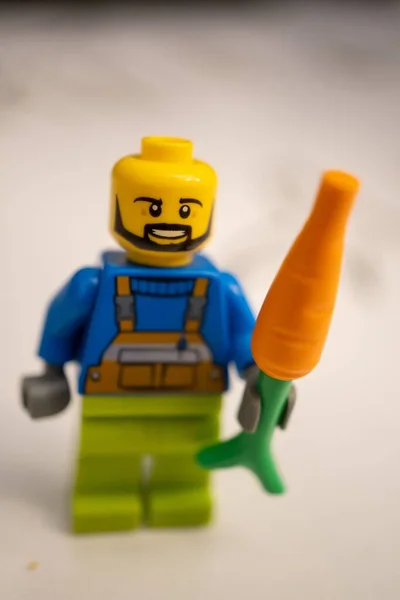 Lego Brand Man Beard Figurine Holding Carrot Vertical — Stock Photo, Image