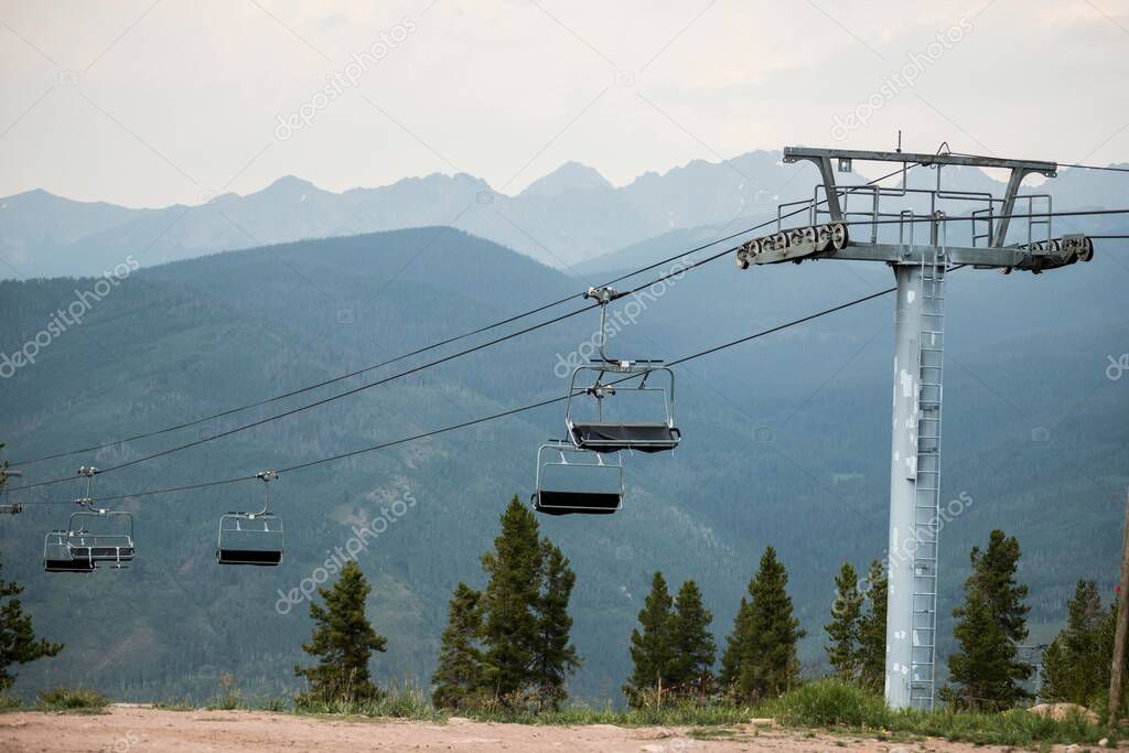 A beautiful shot of a cable car with a background of mountains