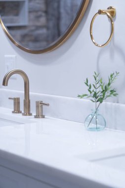 Lavabo ve aynayla modern beyaz banyo içinin dikey görüntüsü.