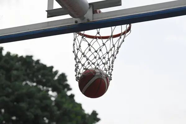 Nízký Úhel Výstřelu Červeného Basketbalu Padajícího Dna Obruče — Stock fotografie