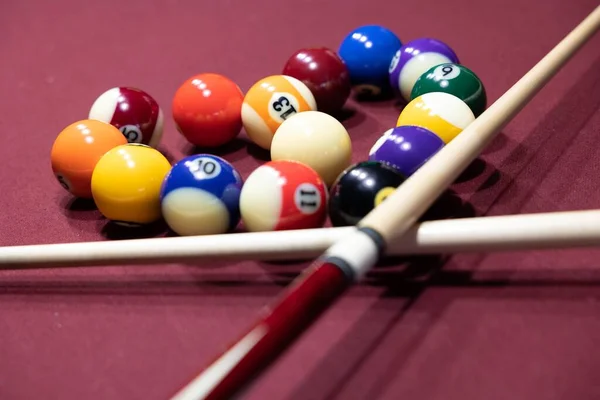 A closeup shot of billiard pool balls arranged into a heart