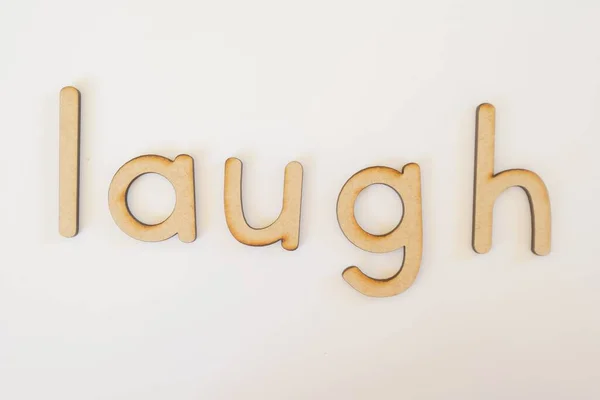 Een Woord Lach Gemaakt Met Houten Letters — Stockfoto