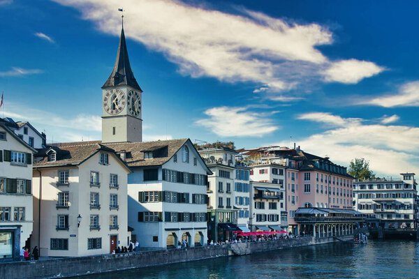 The St. Peter Church with the Limmat river in foreground, Zurich, Switzerland