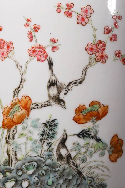 A vertical close-up shot of painted birds on a Chinese vase