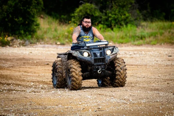 Bearded Tattooed Male Driving Muddy Atv Rock Fest — Stock Photo, Image