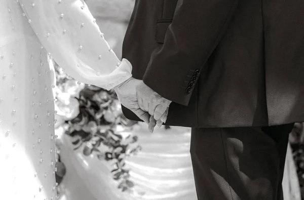 Eine Monochrome Aufnahme Des Brautpaares Beim Händchenhalten Einem Hochzeitstag — Stockfoto