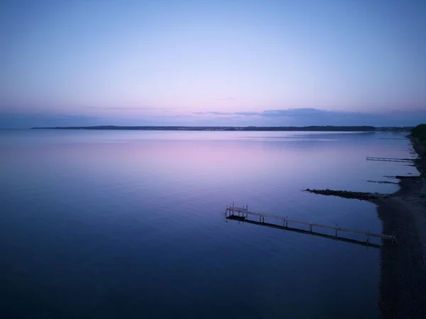 在蓝色和紫色的暮色中 一个码头在海面上的空中景观 — 图库照片