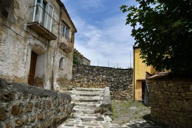 A narrow street between the old houses of Albano di Lucania, a village in the Basilicata region, Italy.