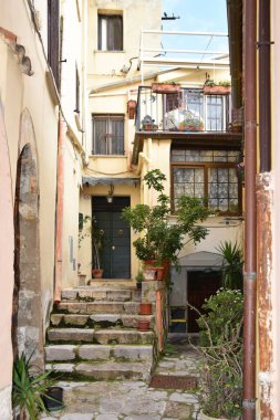 Güneşli bir günde Monte San Biagio 'daki eski dar bir caddenin dikey görüntüsü.