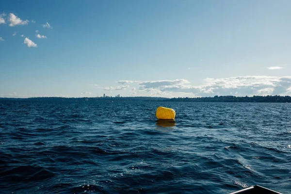 single yellow buoy alone on Lake Washing