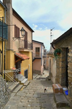 A narrow street between the old houses of Albano di Lucania, a village in the Basilicata region, Italy.