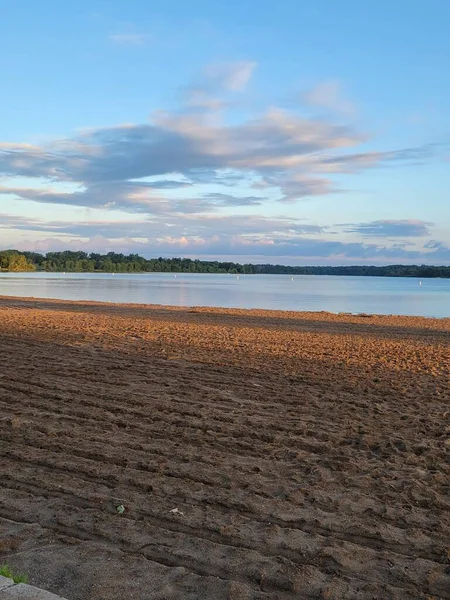 Colpo Verticale Lago Blu Con Una Spiaggia Sabbiosa Tramonto Cielo — Foto Stock