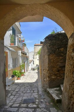 A street between the old houses of Tricarico, a rural village in the Basilicata region, Italy.