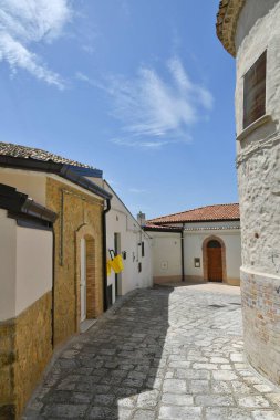 A street between the old houses of Tricarico, a rural village in the Basilicata region, Italy.