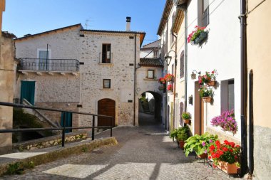 A narrow street between the old stone houses of Cansano, a medieval village in the Abruzzo region of Italy.