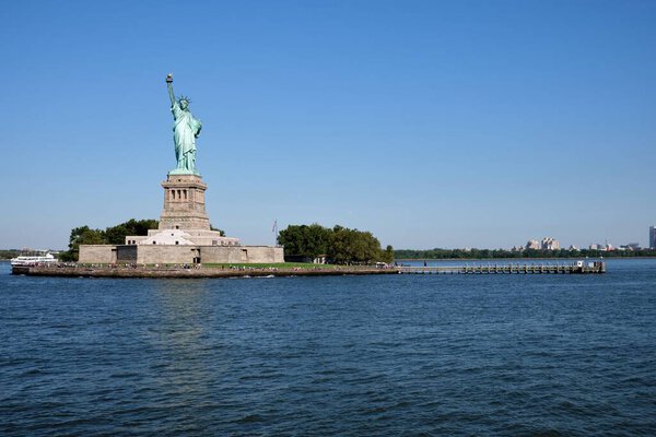 The Statue of Liberty from New York Bay against clear blue sky