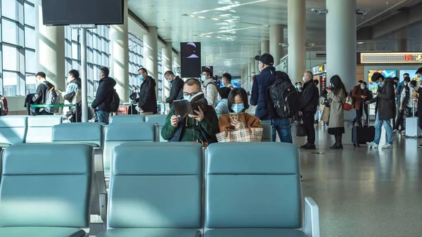 Ένα Ζευγάρι Διαβάζει Ένα Βιβλίο Ενώ Περιμένει Στο Αεροδρόμιο — Φωτογραφία Αρχείου