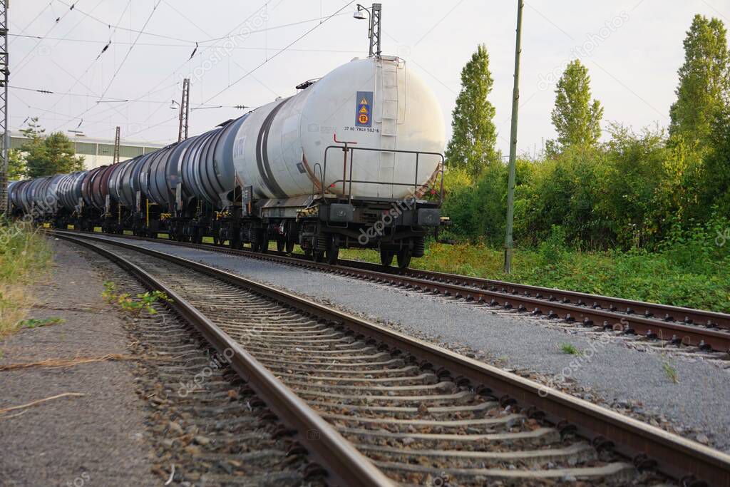 The view of the cargo train with oil tanker cars on the railways
