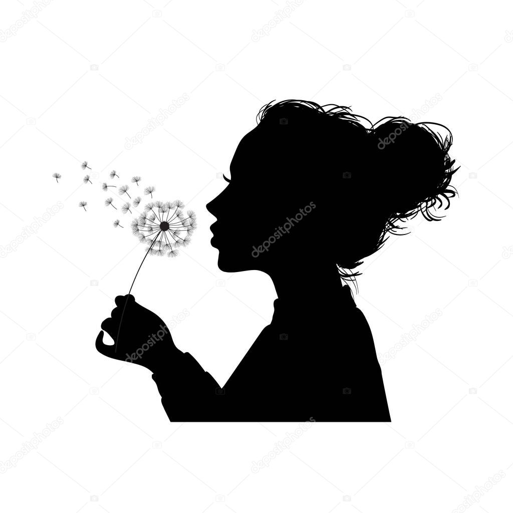 A silhouette of a young girl blowing dandelion