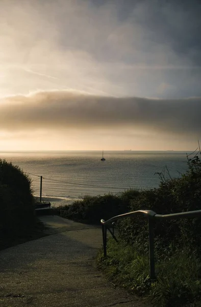 Vertical Shot Road Taking Calm Sea Sole Boat Cloudy Sky — Stock Photo, Image