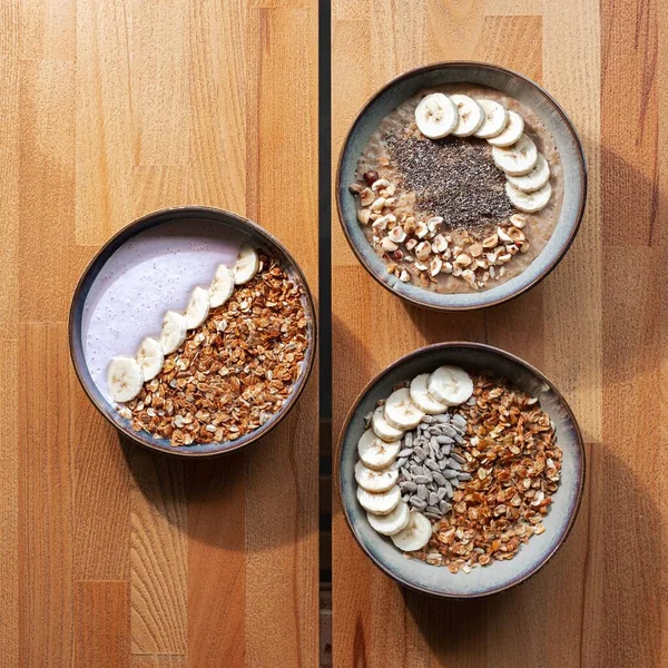 Closeup Breakfast Bowls Bananas Cereal Nuts Wooden Table — Stock Photo, Image