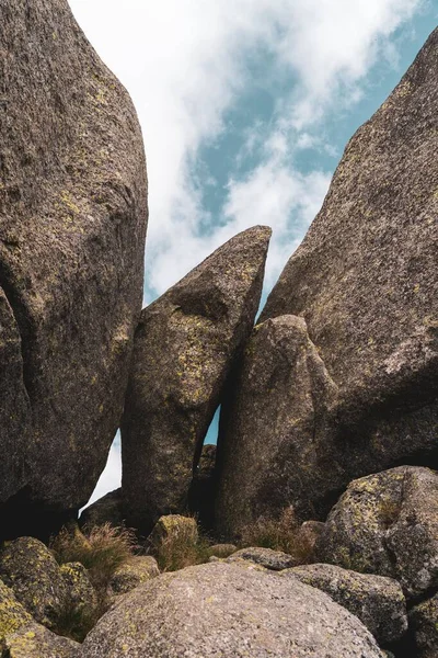 Een Verticaal Schot Van Rotsen Tegen Een Bewolkte Lucht — Stockfoto