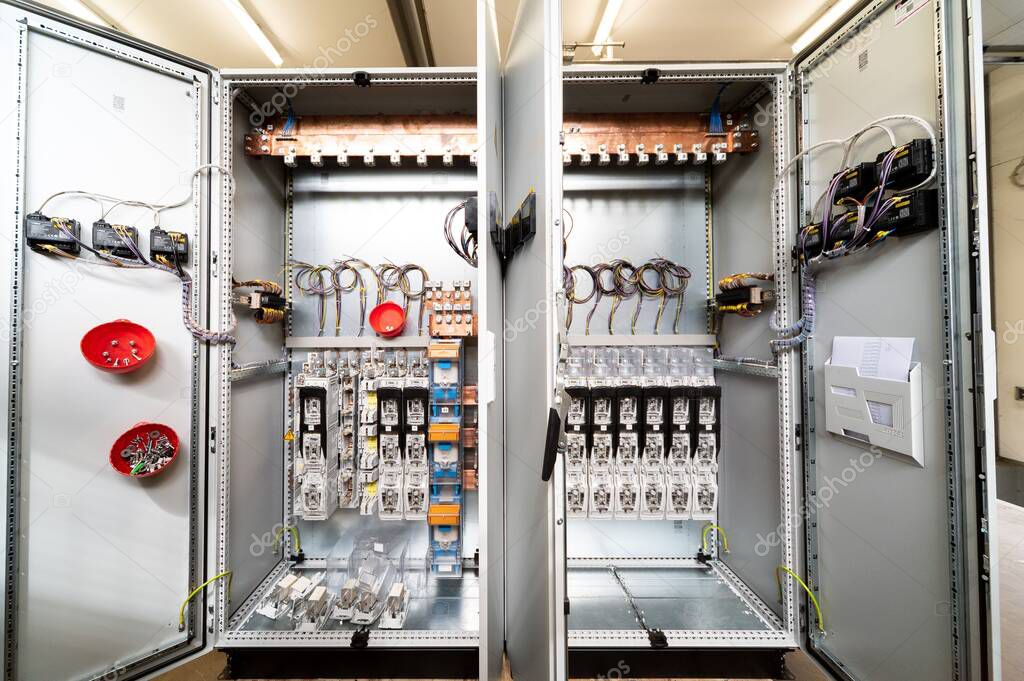 A closeup shot of an electrical switchboard with wires and fuses