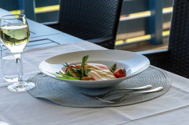 Akşam yemeği tabağı ve bir kadeh şarap yakın çekim.