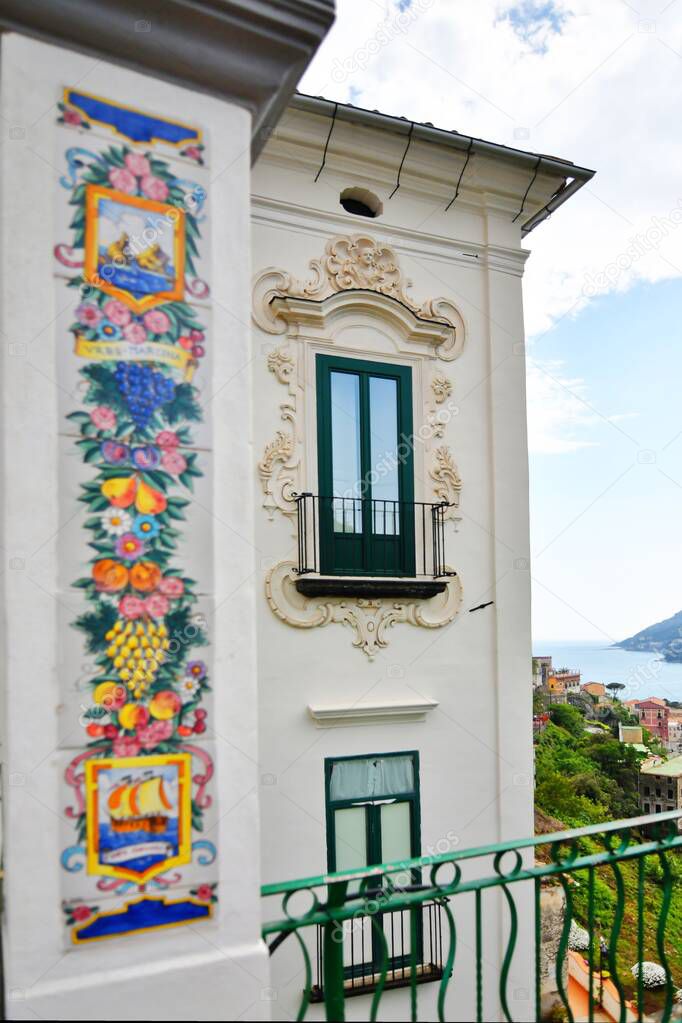 A vertical shot of a balcony and windows of a house with decors near the Amalfi coast, Vietri sul Mare