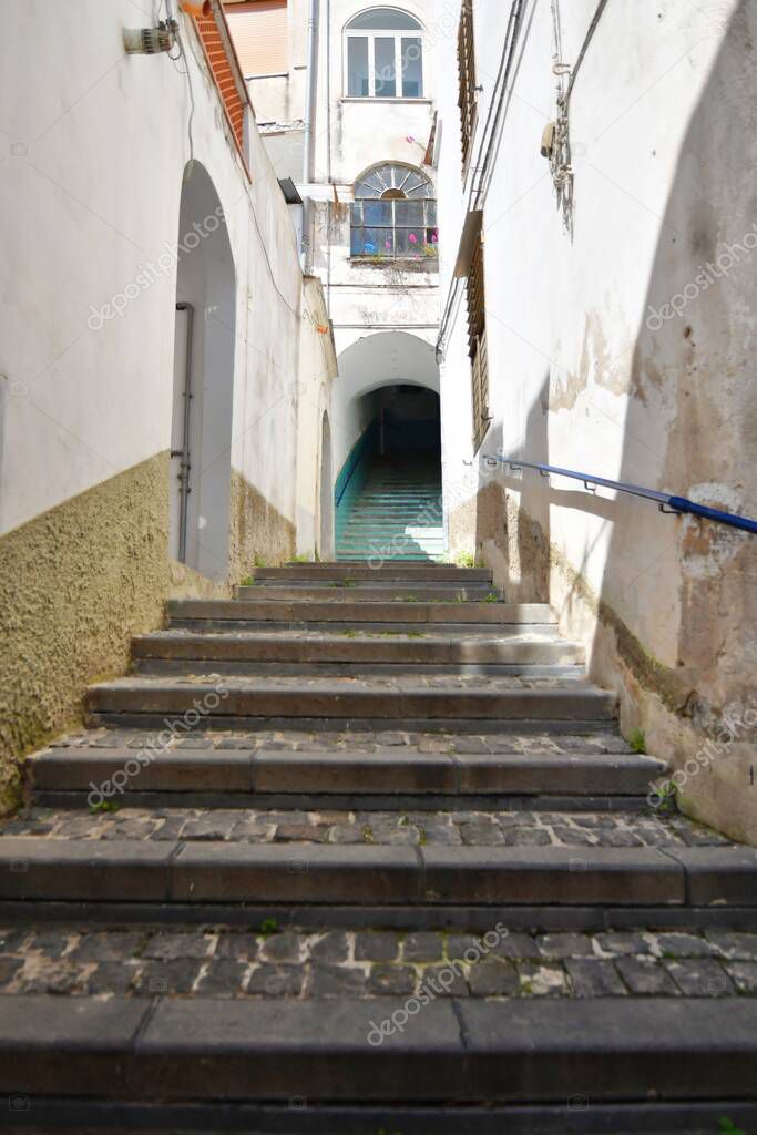 A vertical shot of an old narrow street with stairs leading up in Vietri sul Mare, a village in Italy