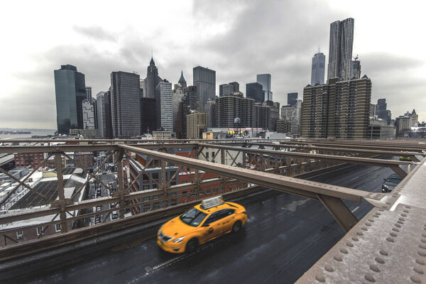 A closeup of the Skyline of New York from the Brooklyn Bridge on a cloudy day
