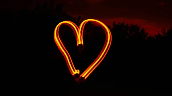 Closeup Shot Glowing Heart Shaped Light Long Exposure — Stock Photo, Image