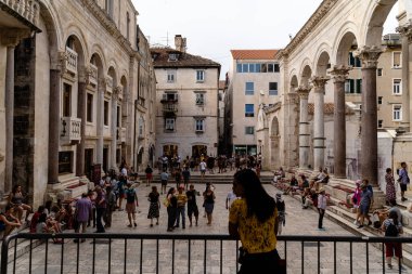Hırvatistan 'ın Split kentinde, turistlerle birlikte orta kare ve kemerlerin bir çekimi.