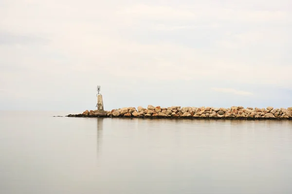 Sakin Denizin Yakınındaki Kayalık Bir Sahilde Bir Deniz Feneri Huzur — Stok fotoğraf