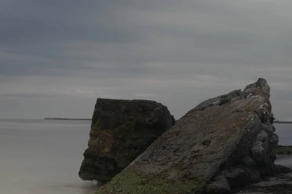Ένα Κοντινό Πλάνο Μεγάλους Βράχους Μια Άδεια Παραλία Μια Ήρεμη — Φωτογραφία Αρχείου