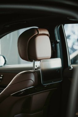 Lüks siyah araba galerisinde dikey bir kafalık ve tablet.