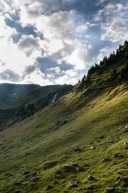 Arka planda bulutlar olan yüksek rakımlı dağların dikey çekimi