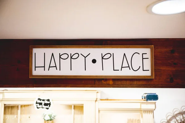 The Happy place sign above the door of the shop in California