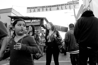 Los Angeles şehir merkezindeki Santee Alley boyunca gri tonda alışveriş yapan insanların sığ bir odağı.